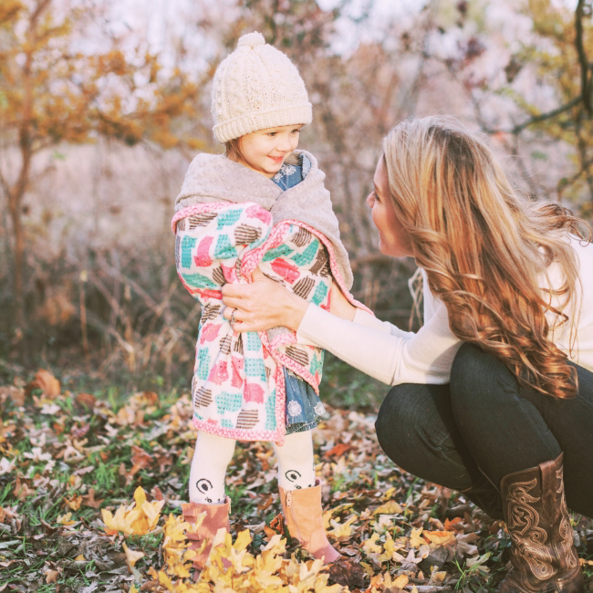 A mother with her happy, healthy child who has benefited from developmental and behavioral pediatrics.